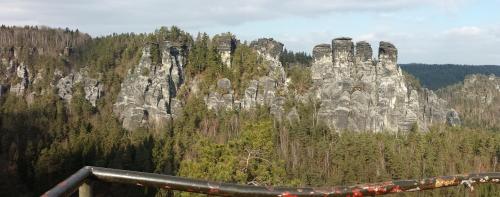 a large rock formation in the middle of a forest at Ferienwohnung Gisela Winkler in Rathen
