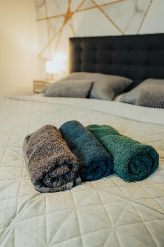 a group of towels sitting on a bed at Apartmány J&J in Šumperk