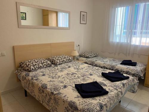 A bed or beds in a room at Apartament La Mata "FELIZ"
