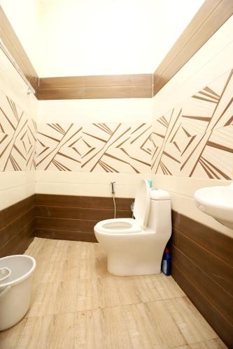 a bathroom with a toilet and a sink at Nest Villa Yelagiri By Lexstays in Yelagiri