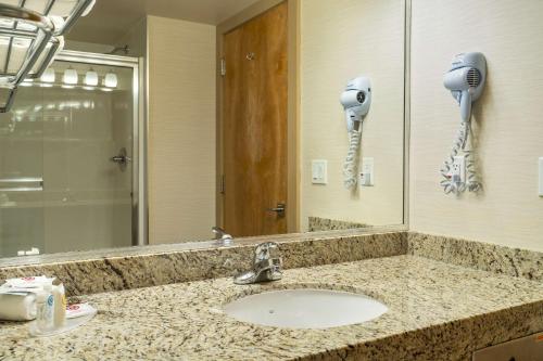 a bathroom with a sink and a phone on the wall at Comfort Inn & Suites in Surrey