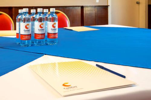 two bottles of water sitting on a blue table at Comfort Inn & Suites in Surrey
