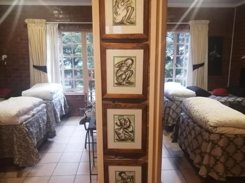 a room with four framed pictures on a wall at Clarens Eddies Guest house in Clarens
