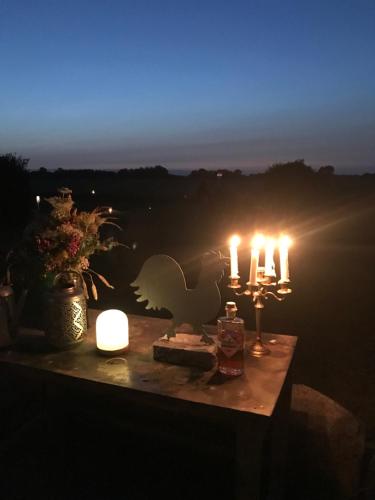 a table with candles on top of a table with a view at Bremsmaj Farm Holiday in Kværs