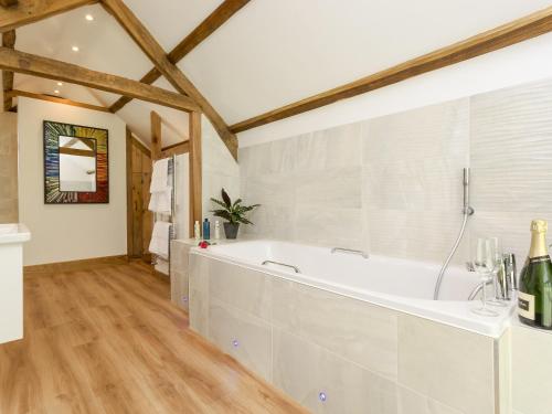 a bathroom with a white tub in a room at The Calf Shed-ukc2113 in Royal Wootton Bassett