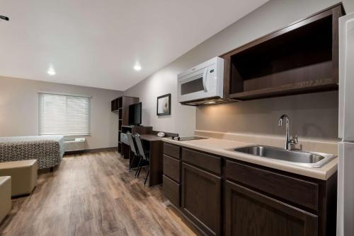 a kitchen with a sink and a counter top at WoodSpring Suites San Antonio UTSA - Medical Center in San Antonio
