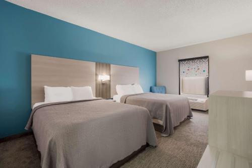 A bed or beds in a room at Quality Inn & Suites