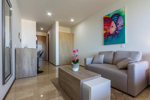 a living room with a couch and a table at Luxury Studios On The 5th avenue Ocean View Rooftop I By Yeah in Playa del Carmen