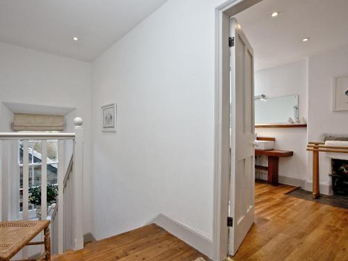 a hallway with white walls and a wooden floor at Lower Margate Bodmin in Bodmin