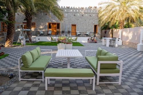 a patio with two chairs and a table at Aryaf hostel in Nizwa