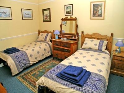 a bedroom with two beds and a sink and a mirror at 41 Eldon Street in York