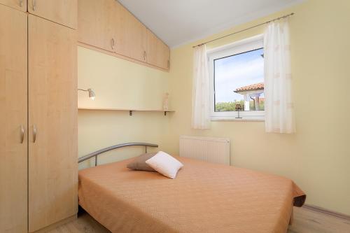 Postel nebo postele na pokoji v ubytování Apartments Ljubica Pulj