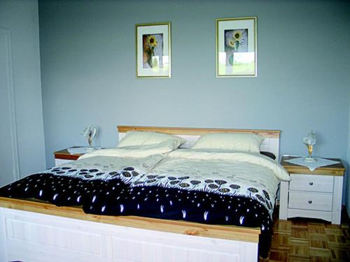 Wiesenhof في اورشولز: غرفة نوم بسرير وصورتين على الحائط