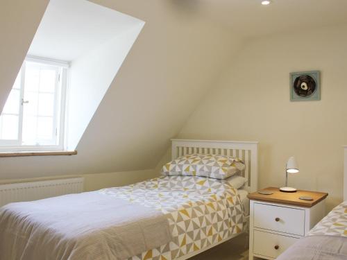 a bedroom with two beds and a window at Anchor Cottage in Deal
