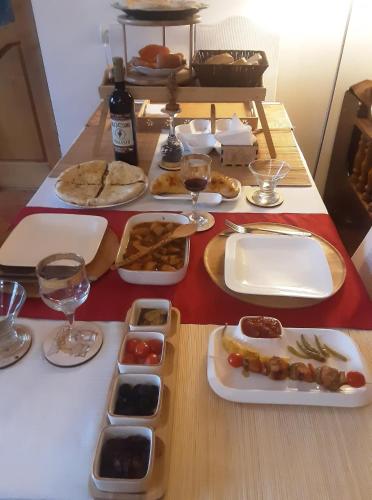 a table with plates of food and glasses of wine at Colchis ca777 in Kutaisi