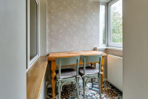 a small kitchen with a table and two chairs at Cool Opera Apartments in Cluj-Napoca