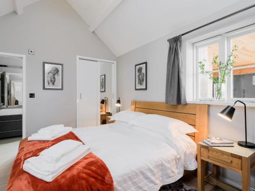 a bedroom with a large white bed and a window at Canal View in Ellesmere