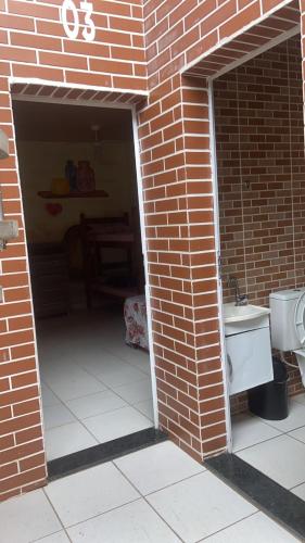 a brick garage with a sink and a toilet at Colônia Virtual Net in Itanhaém