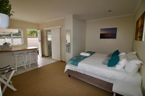 1 dormitorio con 1 cama grande y cocina en Bush 2 Beach Inn en Summerstrand