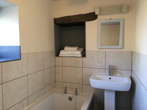 a bathroom with a sink and a bath tub at Boothferry - 18425 in Rosedale Abbey