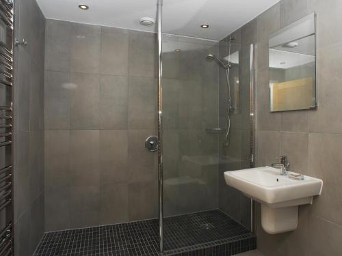 a bathroom with a shower and a sink at Tree Tops - A4 Masts in Torquay