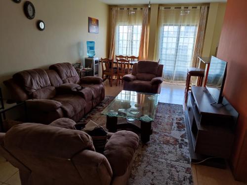 a living room with couches and a coffee table at Nests by Too in Eldoret