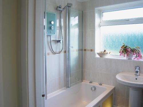 a bathroom with a shower and a sink at Stileaway in Potter Heigham