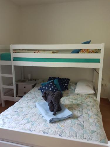 a white bunk bed with a teddy bear on a blanket at Villa Behija Ferienwohnung 3 Crikvenica in Crikvenica