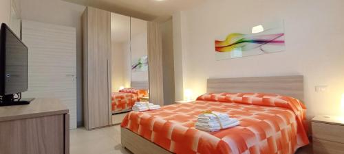 a bedroom with a bed and a tv in it at La Casetta 22 in Andrano