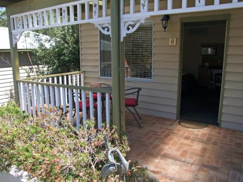 a front porch of a house with a white pergola at Adamsons Riverside Accommodation in Margaret River Town