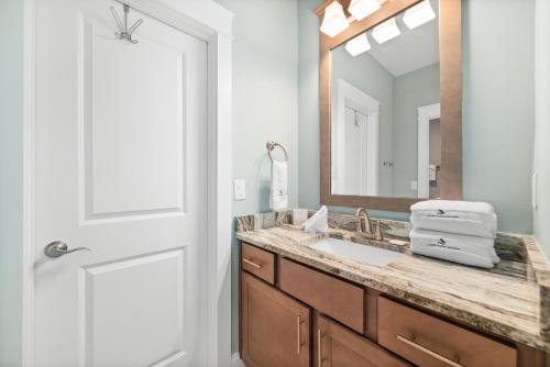 a bathroom with a sink and a mirror at Starfish Cottage in Gulf Shores