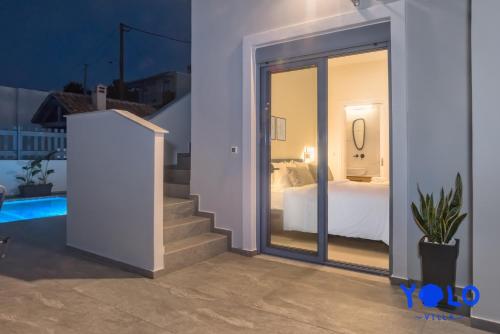 a room with a view of a bed and a window at Villa YOLO in Almirida