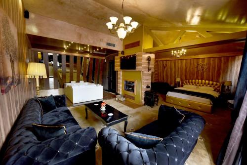 a living room with a couch and a bed at Hotel Hymeti's Palace in Pogradec