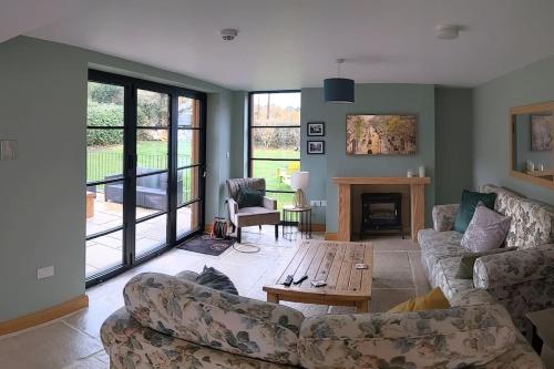 a living room with a couch and a coffee table at Cosy 2 Bedroom Coach House in Belfast