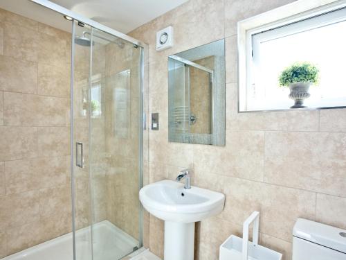 a bathroom with a sink and a shower at Cornerstone in Castletown