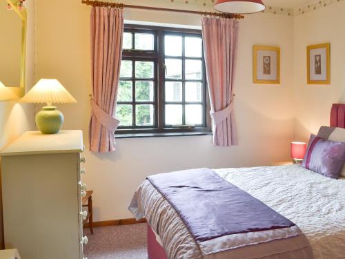 a bedroom with a bed and a window at The Berry - 15607 in Marldon