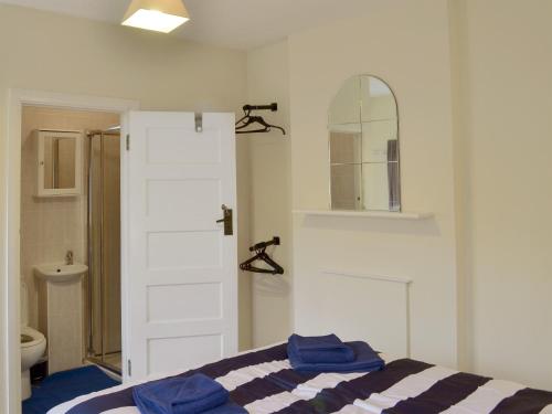 a bedroom with a bed with blue towels on it at Rosehill in Goodrington