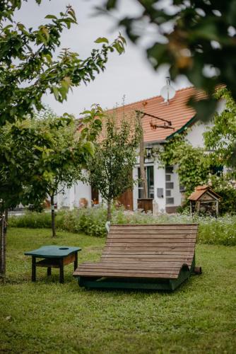 a park bench with a table in the grass at Landhaus Schaller im Südburgenland in Maria Bild