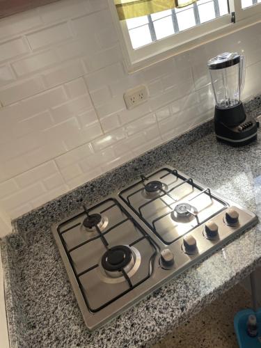 a kitchen stove with a blender on a counter at Cristian suit in Ensanche Savica de Mendoza