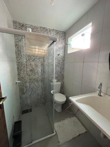 a bathroom with a shower and a toilet and a sink at Apartamento 2 - CARUARU-PE in Caruaru