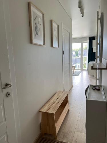 a living room with a wooden bench on the wall at PUŠIS IR JŪRA - Mano Jūra 2 complex - Kunigiškiai in Palanga