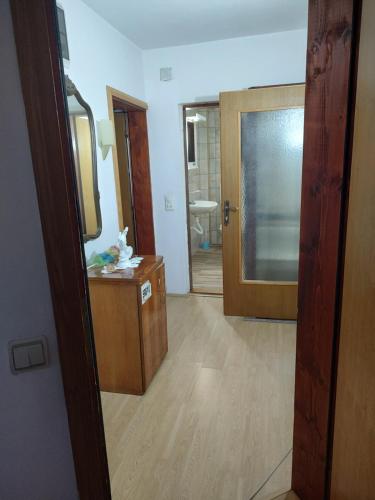 a room with a bathroom with a mirror and a door at Vojin Meljak in Meljak