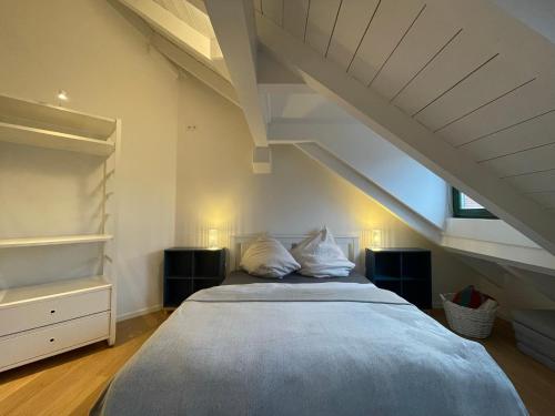 a bedroom with a large bed in a attic at Gemütliches Loft in Geretsried