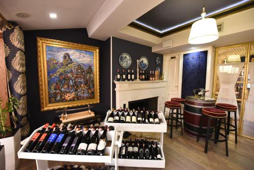 a room filled with lots of bottles of wine at Hotel Hymeti's Palace in Pogradec