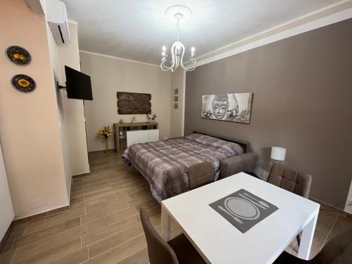 a bedroom with a bed and a table and a dining room at ATTICO BRICCARELLO -Intero Appartamento- Elegant Suite with FREE WIFI near PalaAlpitour and Sporting Club Torino-Olimpyc Stadium in Turin