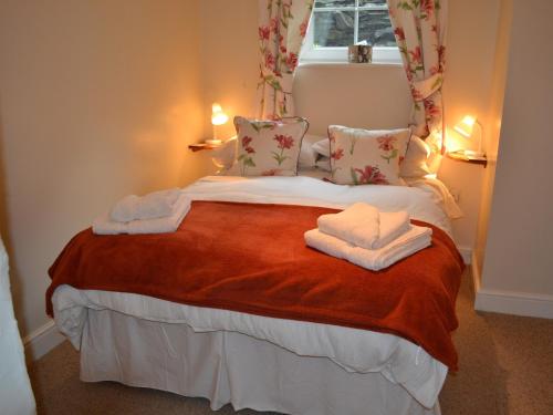 a bedroom with a bed with towels on it at 2 Seed Howe in Staveley