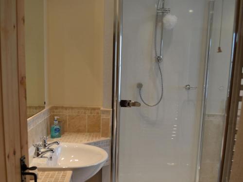 a bathroom with a sink and a shower at 2 Seed Howe in Staveley