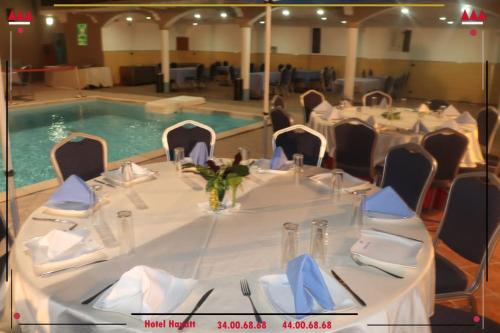 a table set up for a banquet next to a swimming pool at Hotel Hayatt in Nouakchott