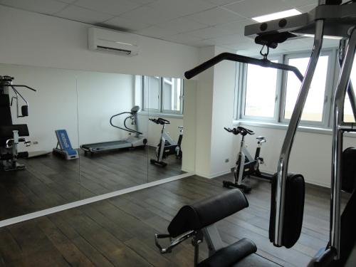 a gym with treadmills and exercise bikes in a room at Cosmopolitan Hotel in Civitanova Marche