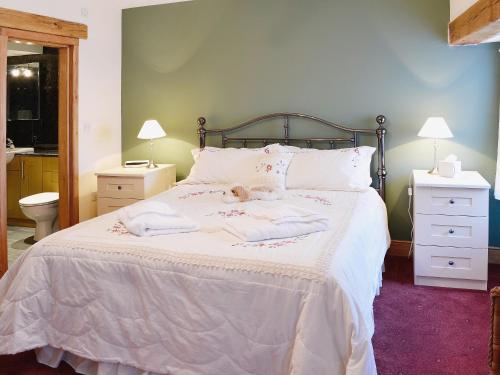 a bed with two towels and a stuffed animal on it at Bram Crag Barn in Legburthwaite